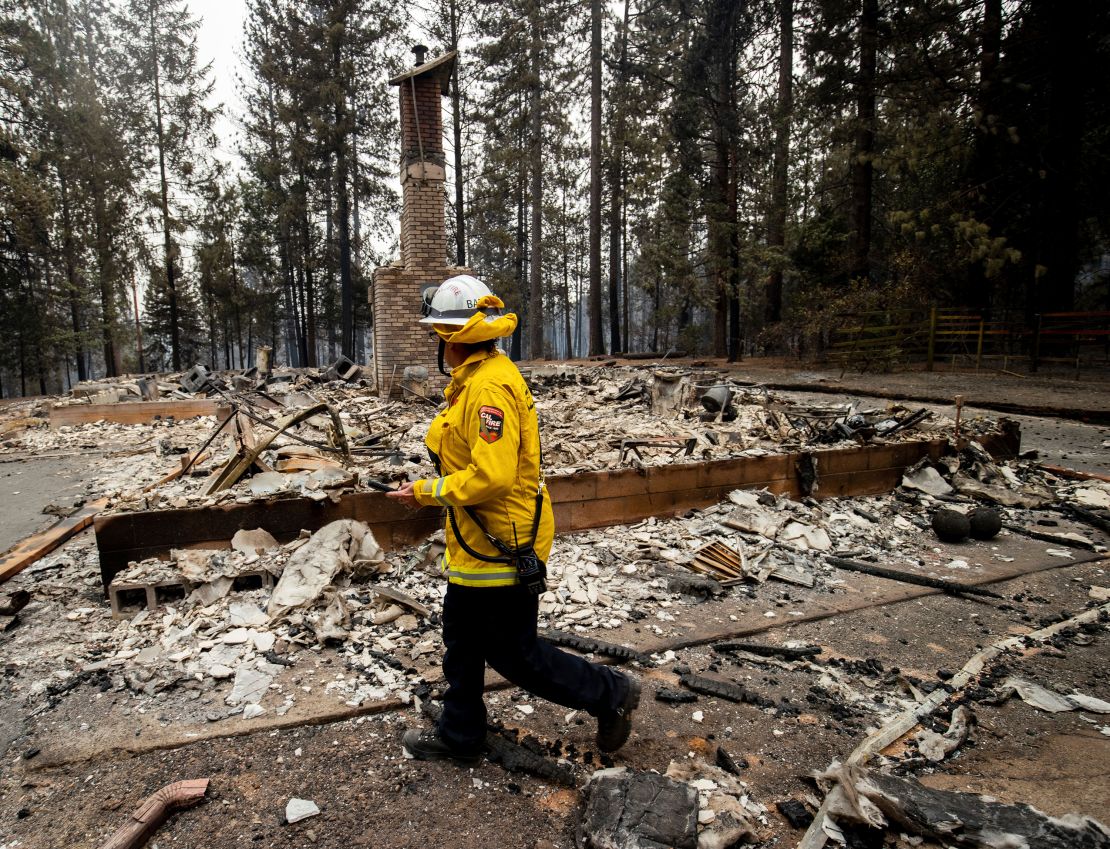 Cal Fire Division Chief Carmel Barnhart inspects a property after the Caldor Fire burned through Grizzly Flats, California, on Wednesday, August 18. 