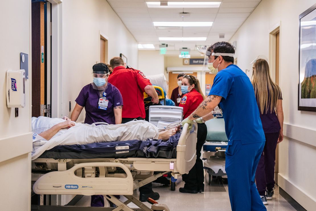 Emergency Room nurses and EMTs tend to patients in hallways at the Houston Methodist The Woodlands Hospital on August 18, 2021 in Houston, Texas. Across Houston, hospitals have been forced to treat hundreds of patients in hallways and corridors as their emergency rooms are being overwhelmed due to the sharp increase in Delta variant cases.