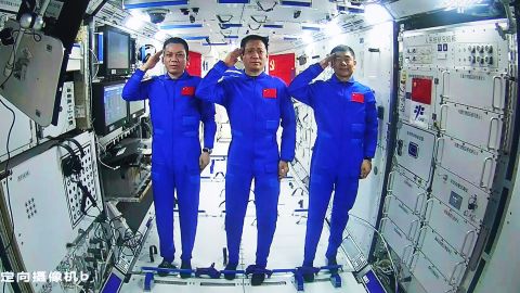 Chinese astronauts, from left Tang Hongbo, Nie Haisheng, and Liu Boming salute from aboard China's space station core module on June 23.