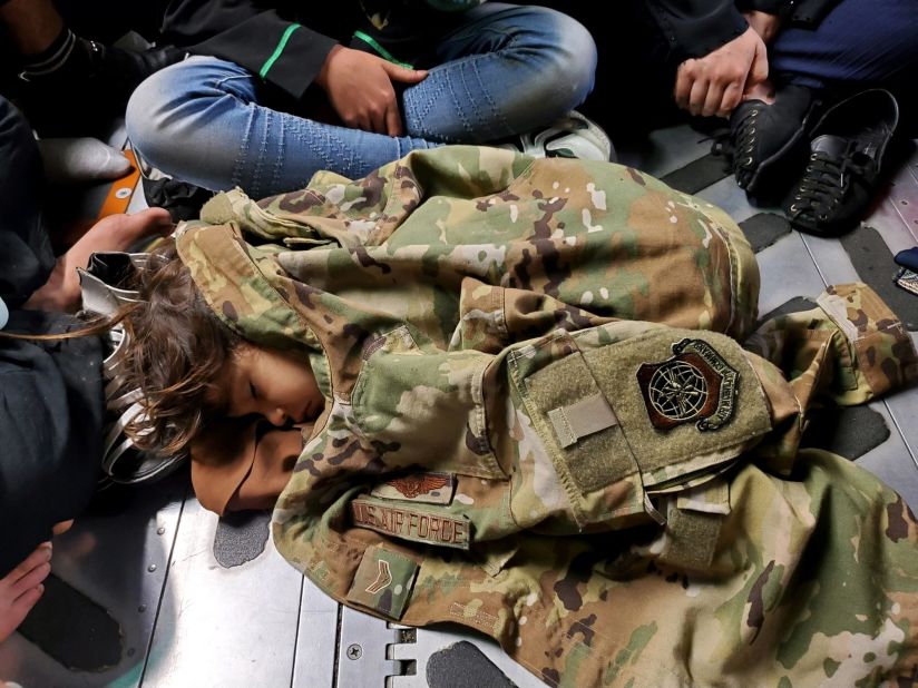 In this photo released by the US Air Force, an Afghan child sleeps on the floor of an Air Force transport plane during an evacuation flight out of Kabul on August 15.