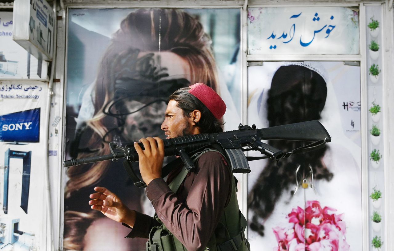 A Taliban fighter walks past a beauty salon in Kabul where images of women had been defaced by spray paint. As news broke that the Taliban had captured Kabul, some images of uncovered women <a href="https://www.cnn.com/2021/08/16/middleeast/kabul-streets-taliban-regime-intl/index.html" target="_blank">were painted over in the Afghan capital.</a> When the Taliban last ruled in Afghanistan, women were barred from public life and only allowed outside when escorted by men and dressed in burqas.