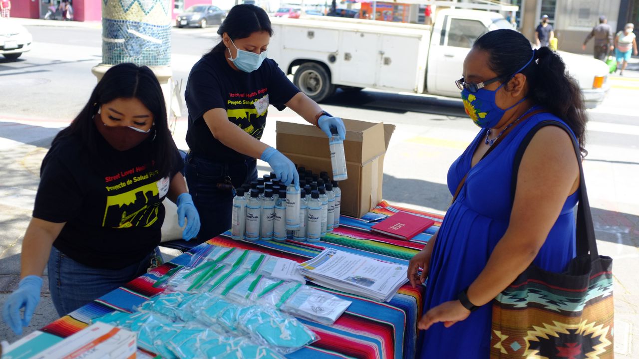 Shirley Pablo Perez and Hilda Lorenzo, members of the Street Level Health Project's covid-19 outreach and education team, distribute PPE in the Fruitvale neighborhood of Oakland, California on May 2021. They are some of the Mam community members who joined the group in recent years.