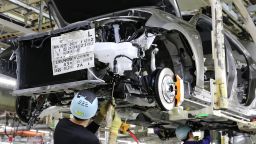 Workers of Japanese automobile giant Toyota Motor assemble auto parts to Lexus GS at the company's Motomachi plant in Toyota city near Nagoya, central Japan on July 30, 2018. 