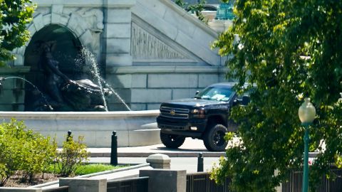 A pickup truck is parked on the sidewalk in front of the Library of Congress' Thomas Jefferson Building, as seen from a window of the U.S. Capitol, Thursday, Aug. 19, 2021, in Washington. A man sitting in the pickup truck outside the Library of Congress has told police that he has a bomb, and that's led to a massive law enforcement response to determine whether it's an operable explosive device.