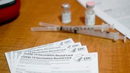 A COVID-19 Vaccination Record Card from the CDC with two syringes, a bottle of COVID-19 vaccine and a vial of saline in a nursing center in Bern Township, PA on January 29, 2021.