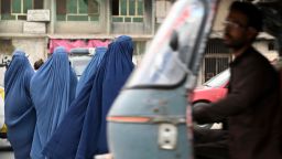TOPSHOT - Women wearing a burqa wait for a local taxi in Kabul on July 31, 2021. (Photo by SAJJAD HUSSAIN / AFP) (Photo by SAJJAD HUSSAIN/AFP via Getty Images)