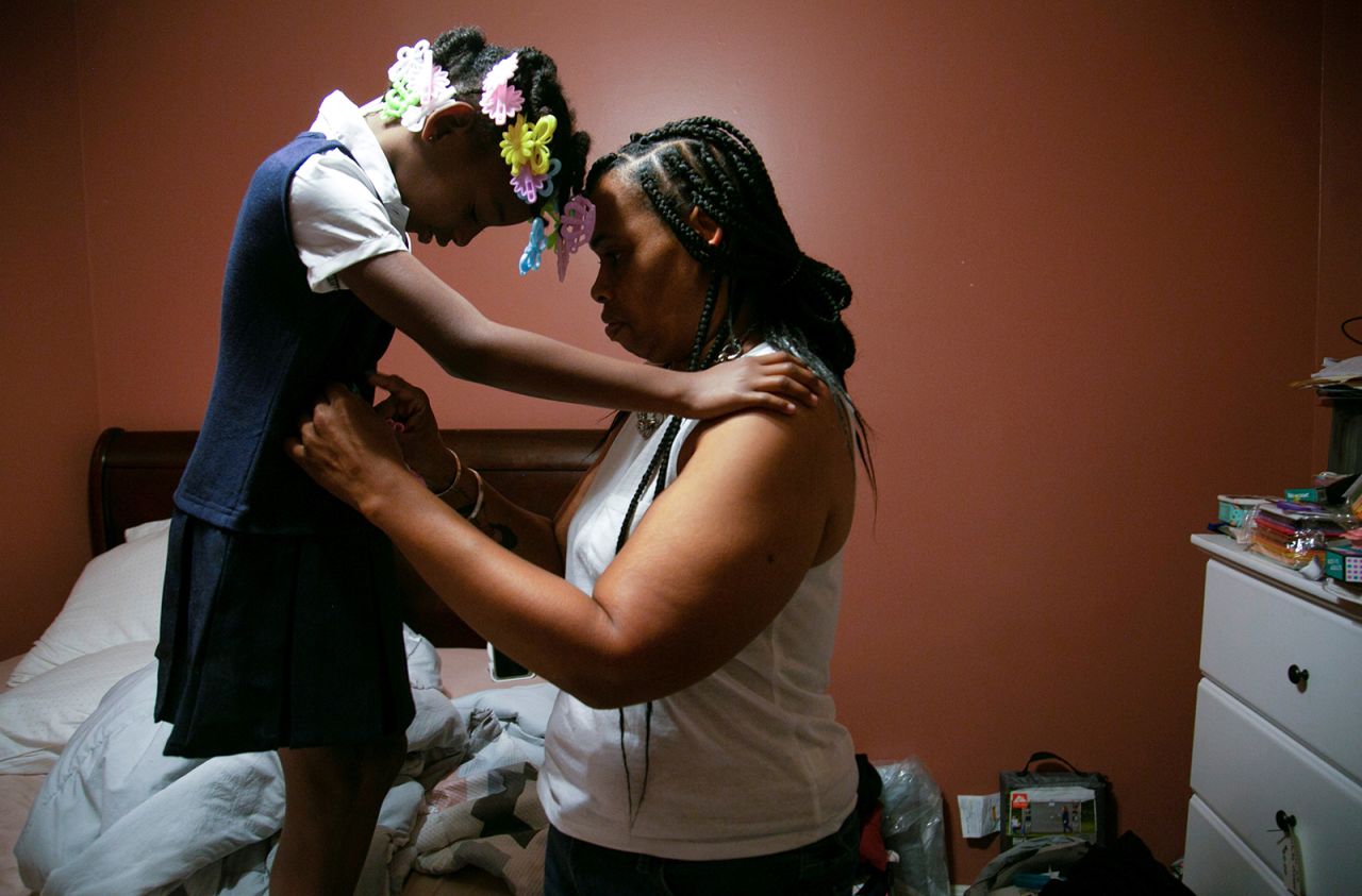Chaunda Lee, a single mother of eight who has five children living with her, prepares her youngest child, MiAsia Carr, for school in Louisville, Kentucky, on Monday, August 16. Lee and her family were facing eviction this week, but they were granted a reprieve as the <a href="https://www.cnn.com/2021/08/13/politics/eviction-moratorium/index.html" target="_blank">federal eviction moratorium</a> was applied to their case. Lee lost her previous home to a fire on Christmas Day, <a href="https://www.courier-journal.com/story/news/local/2020/12/27/louisville-woman-known-cooking-protesters-loses-home-fire/4053833001/" target="_blank" target="_blank">according to the Louisville Courier Journal.</a>