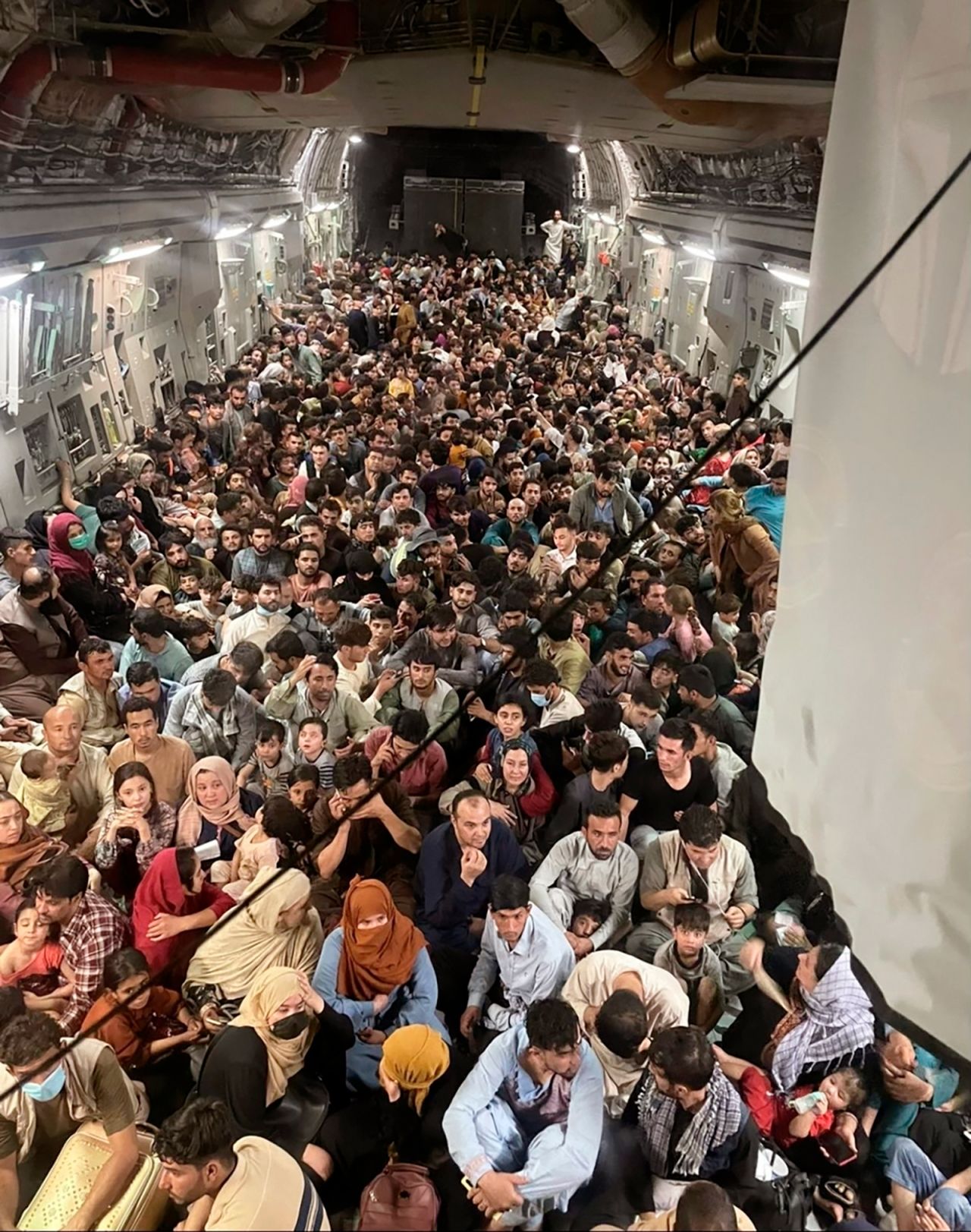Evacuees crowd the interior of a US Air Force transport plane as they travel out of Kabul, Afghanistan, on Sunday, August 15.