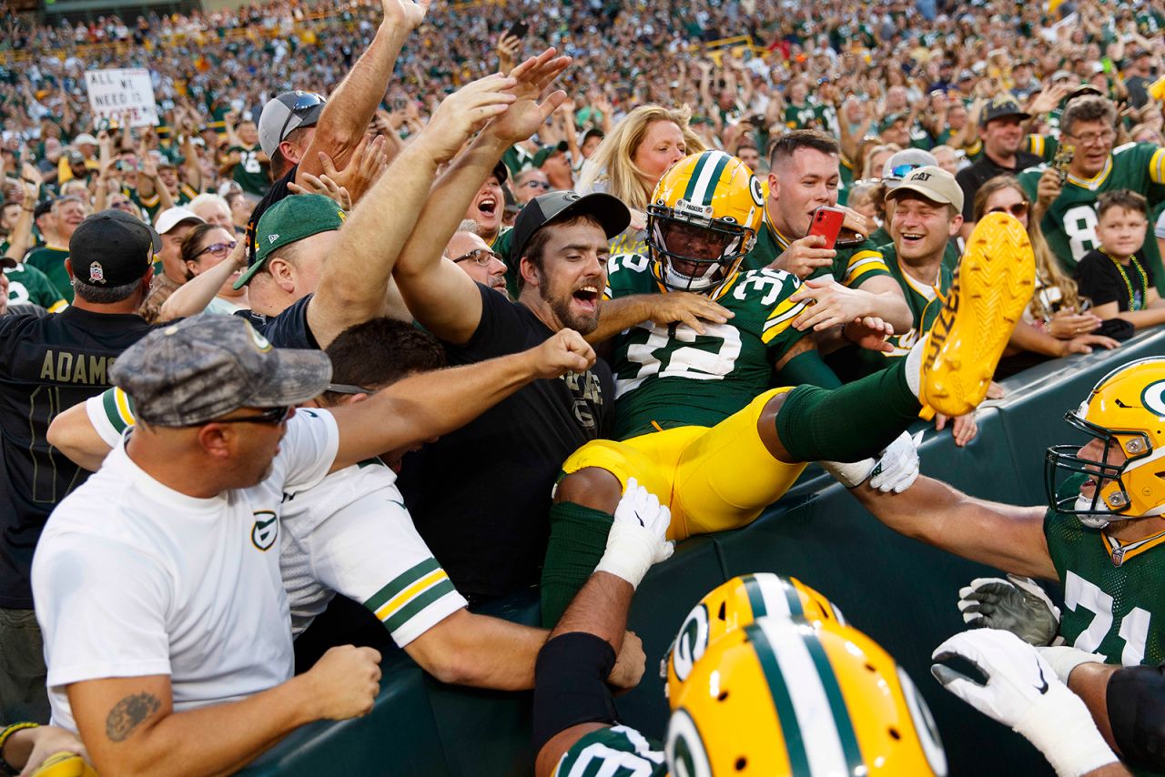 Green Bay running back Kylin Hill celebrates with fans after scoring a touchdown during an NFL preseason game on Saturday, August 14.