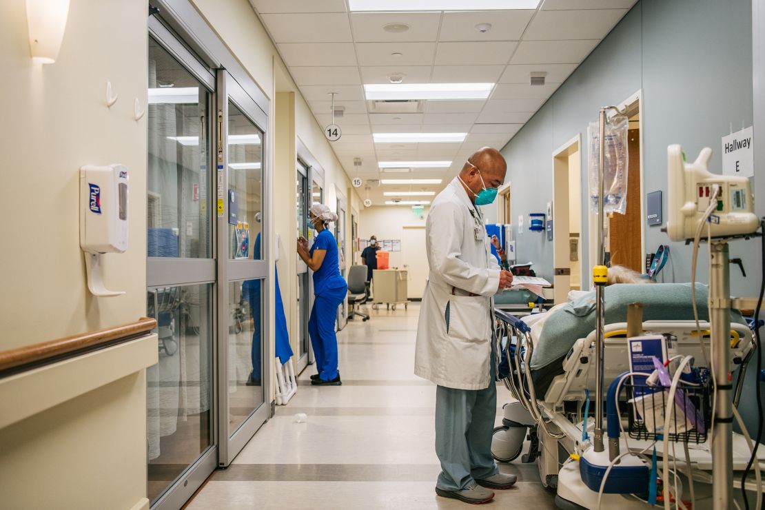 Dr. Michael Nguyen tends to a patient in a hallway at the Houston Methodist The Woodlands Hospital on August 18, 2021.