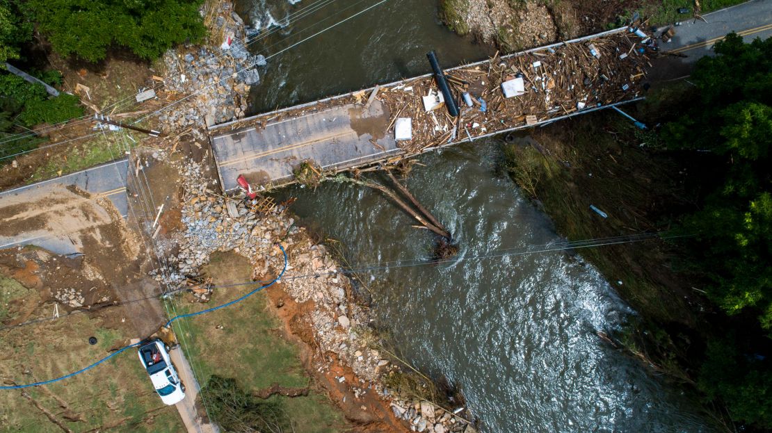 In this image taken with a drone, a damaged bridge spans the Pigeon River in Bethel, North Carolina, after remnants from Tropical Storm Fred caused flooding.