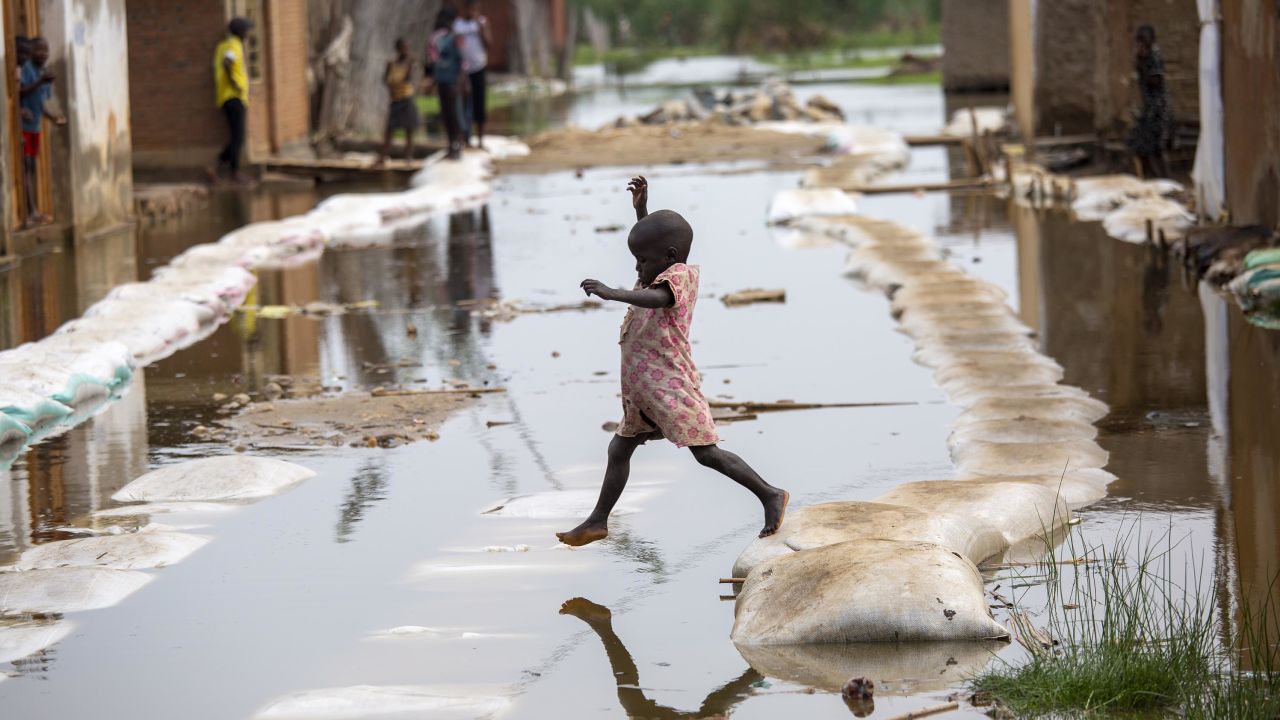 A child plays in the floodwaters in Gatumba in Burundi on March 4, 2021.