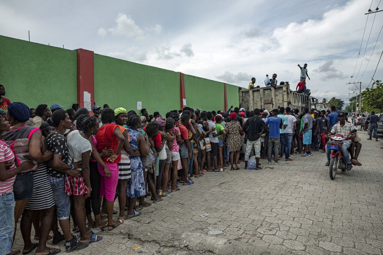 People wait in line for food to be distributed in Les Cayes, Haiti, on Thursday, August 19.
