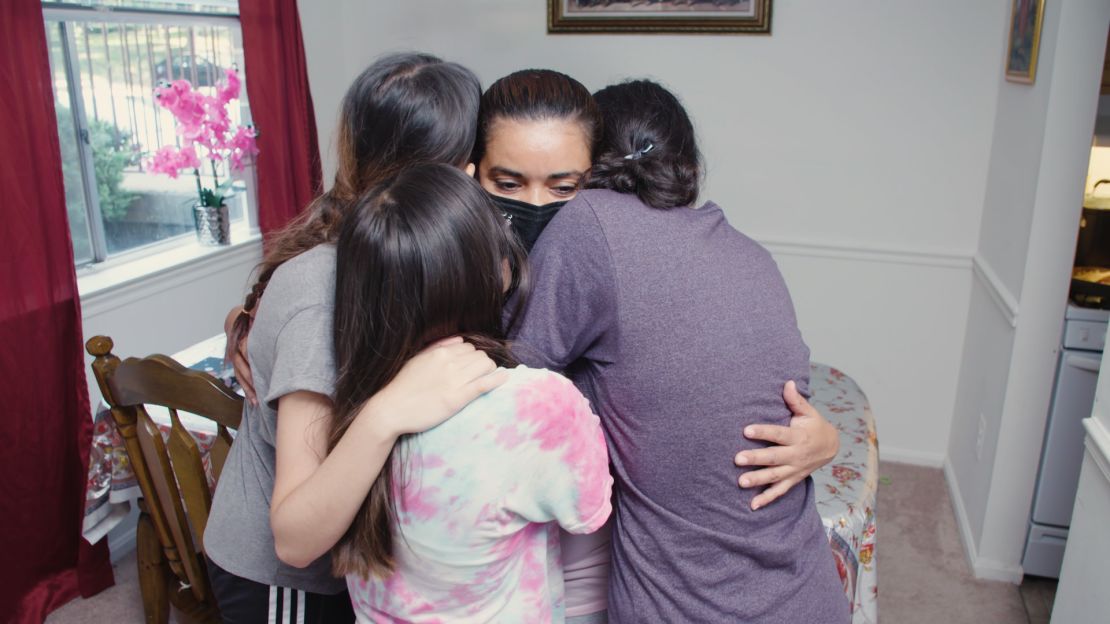 Juana hugs three of her daughters, about a month after they were reunited in the United States.