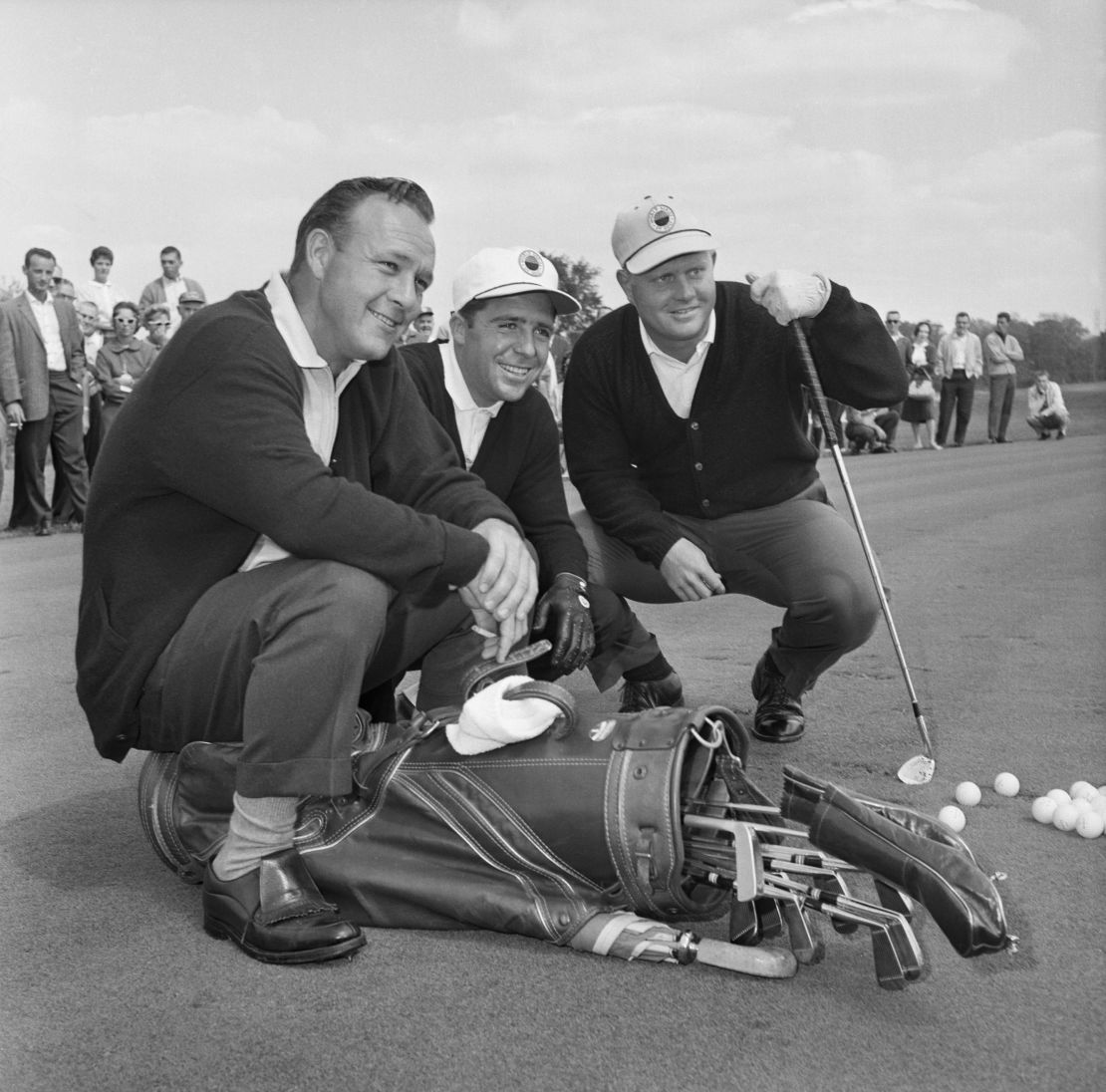 Palmer, Player and Nicklaus pose with their golf clubs before a practice round at the Firestone Country Club in Akron, Ohio.