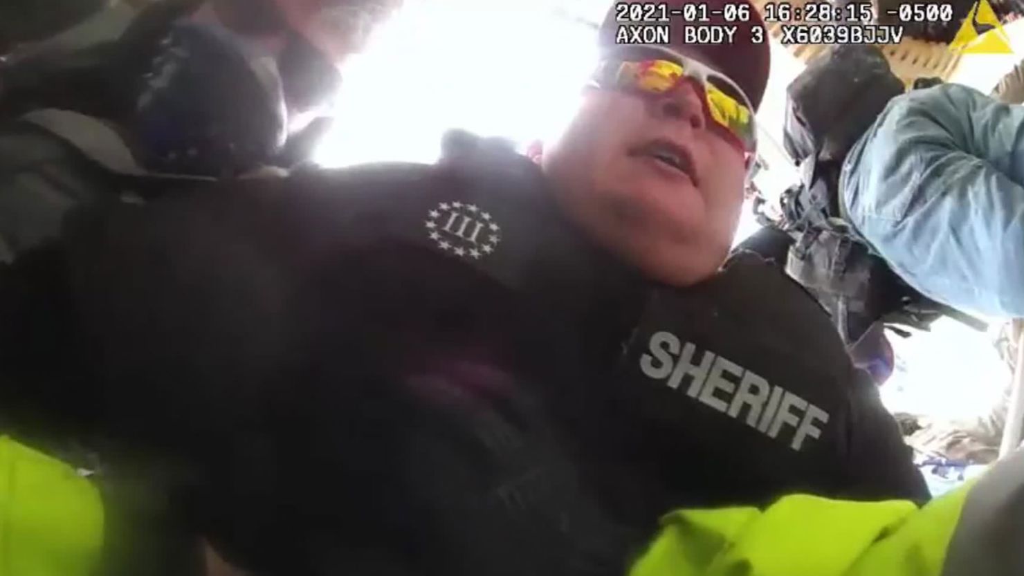 The Justice Department says this image, taken from police bodycam footage, shows then-Deputy Sheriff Ronald McAbee dragging a police officer into the violent crowd outside the US Capitol on January 6.