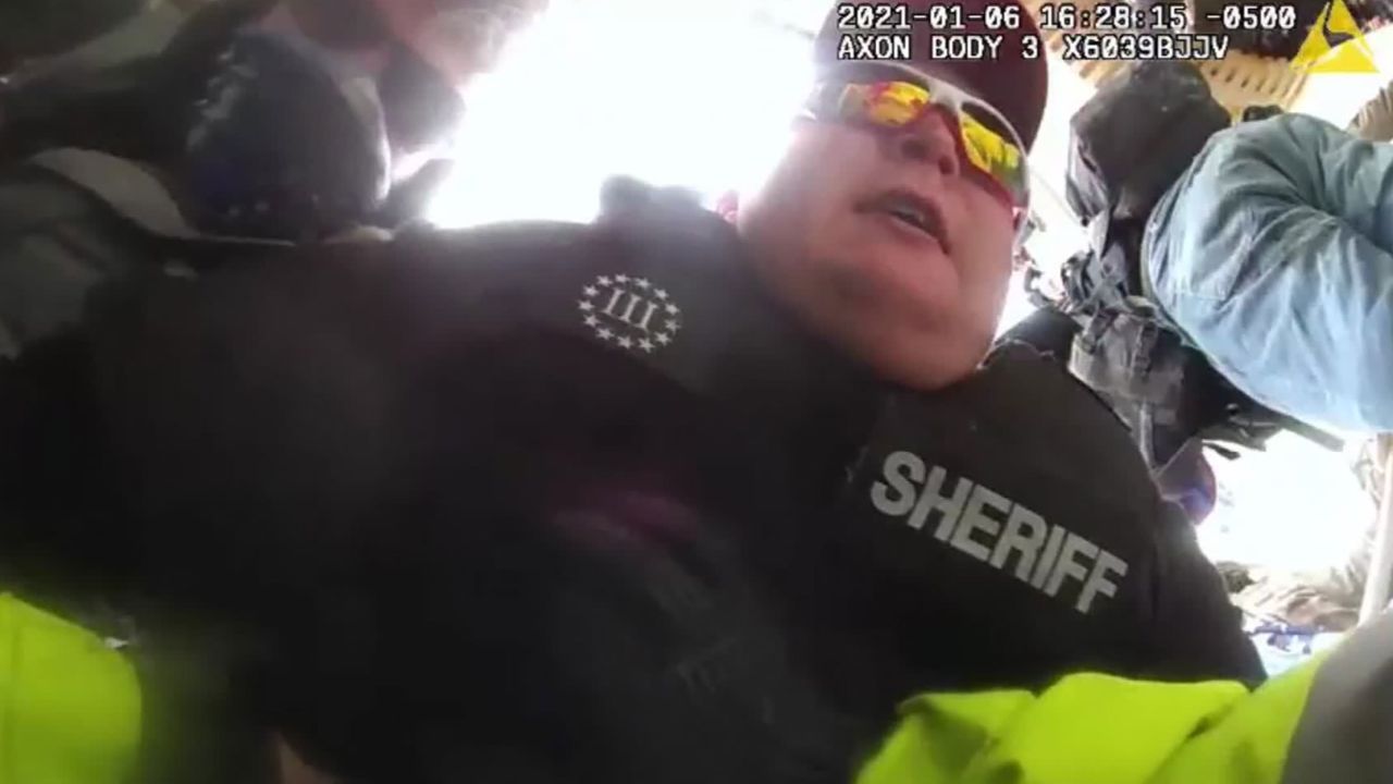 The Justice Department says this image, taken from police bodycam footage, shows then-Deputy Sheriff Ronald McAbee dragging a police officer into the violent crowd outside the US Capitol on January 6.