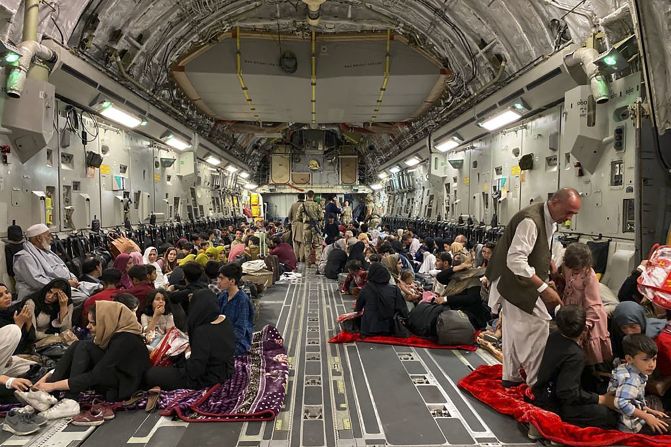 Afghans sit inside a US military aircraft to leave Kabul on August 19. The US Air Force <a href="index.php?page=&url=https%3A%2F%2Fwww.cnn.com%2Fworld%2Flive-news%2Fafghanistan-taliban-us-news-08-20-21%2Fh_e066c6b39a904ab84d766a8f77176b1f" target="_blank">evacuated approximately 3,000 people from Kabul's international airport that day,</a> according to a White House official. Nearly 350 US citizens were among the evacuees, the official said, with the others being family members of US citizens, Special Immigrant Visa applicants and their families, and other vulnerable Afghans. Some civilian charter flights had also departed the Kabul airport in the previous 24 hours.