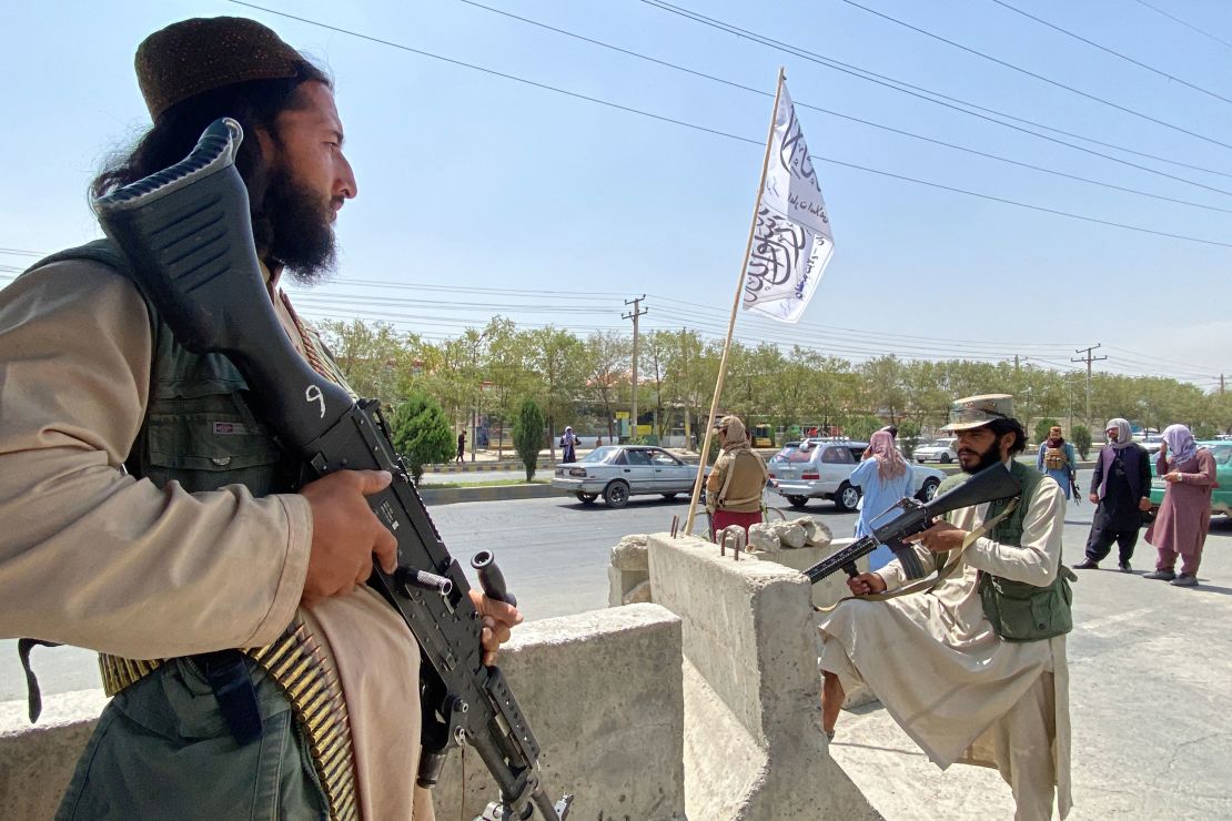 Taliban fighters stand guard outside the Interior Ministry in Kabul on Tuesday, August 17.
