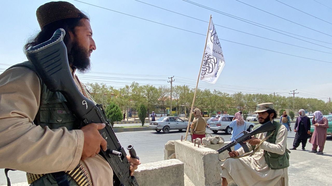 Taliban fighters stand guard at an entrance gate outside the Interior Ministry in Kabul on August 17, 2021. 
