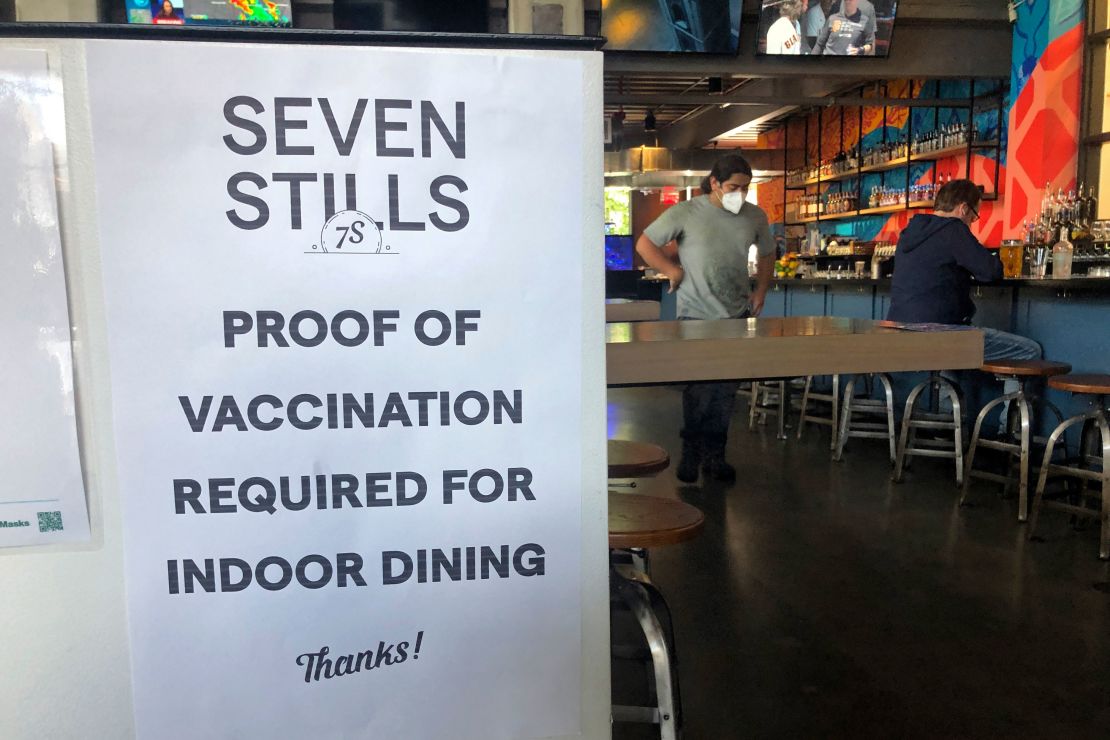 A proof of vaccination sign is posted at a San Francisco bar on July 29, 2021