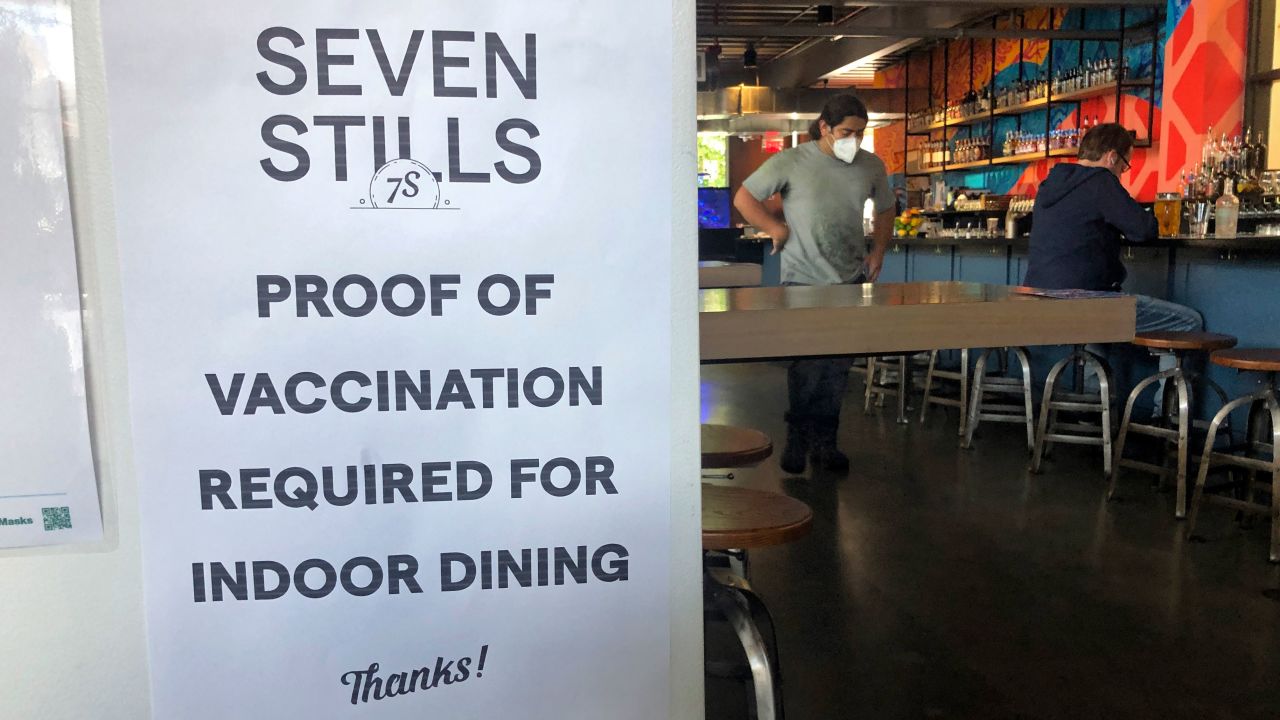 A proof of vaccination sign is posted at a bar in San Francisco on Thursday, July 29, 2021. Until now, many employers had taken a passive approach to their unvaccinated workers, relying outreach and incentives. But that has been shifting, with vaccine mandates gaining momentum. (AP Photo/Haven Daley)