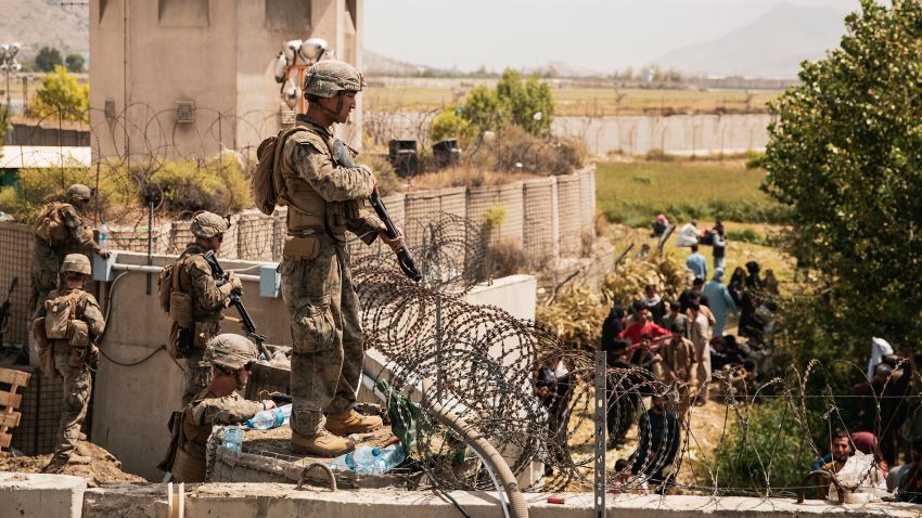 In this image provided by the U.S. Marine Corps, Marines assist with security at an evacuation control checkpoint during an evacuation at Hamid Karzai International Airport in Kabul, Afghanistan, Friday, Aug. 20, 2021. (Staff Sgt. Victor Mancilla/U.S. Marine Corps via AP)