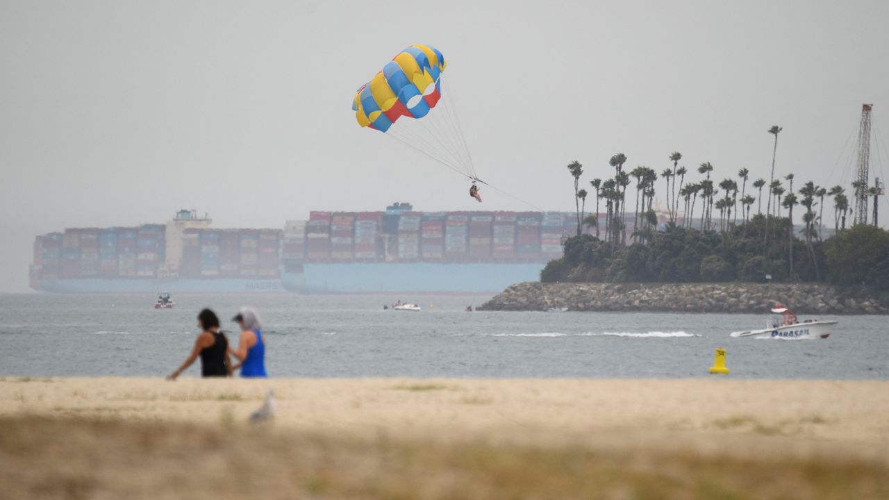 Container ships sit in the Pacific Ocean outside the Port of Long Beach, California on August 11, 2021. 