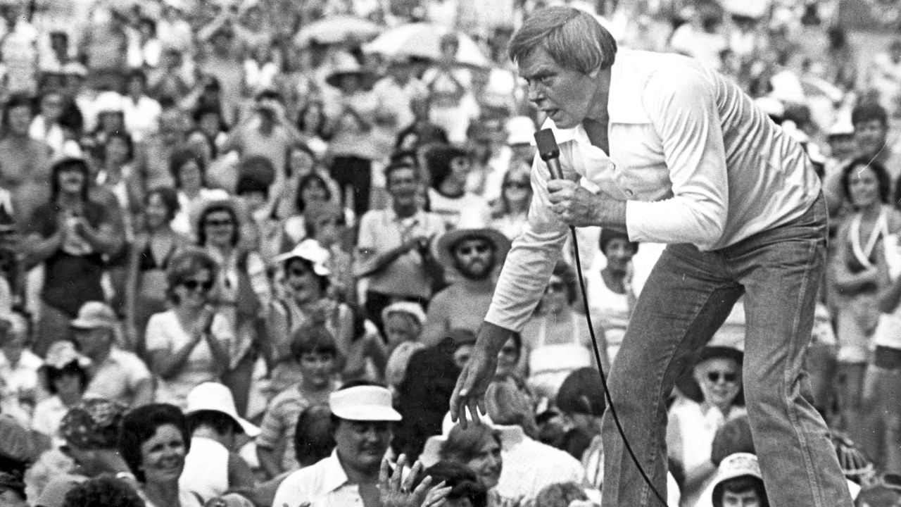 Tom T. Hall leans to the edge of the stage at the Jamboree in the Hills to meet the people near St. Clairsville, Ohio, on July 16, 1977.