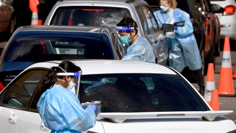 Medical personnel take details at a drive-through Covid-19 testing station in Melbourne in August as Australia battled an outbreak of the Delta variant of coronavirus.