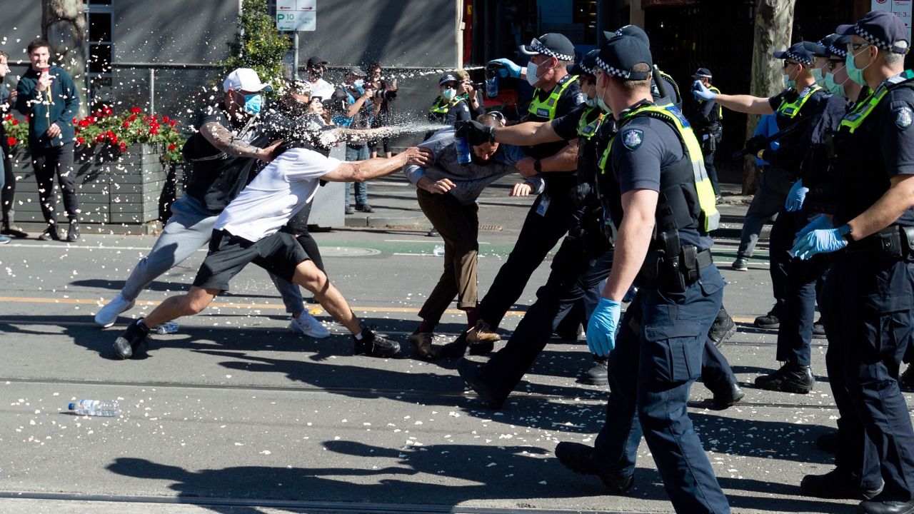 Police deploy capsicum spray on protesters in Melbourne.