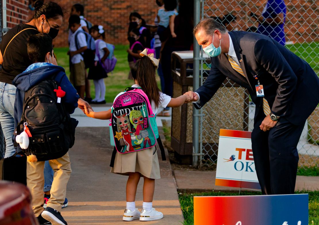 Oklahoma City Public School Superintendent Dr. Sean McDaniel gives fist bumps to students as they arrive at Rockwood Elementary for Oklahoma City Public Schools first day of class on Monday, Aug. 9, 2021, in Oklahoma City, Oklahoma.