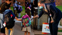 Oklahoma City Public School superintendent Dr. Sean McDaniel gives fist bumps to students as they arrive at Rockwood Elementary for Oklahoma City Public Schools first day of class on Monday, Aug. 9, 2021, in Oklahoma City, Okla.