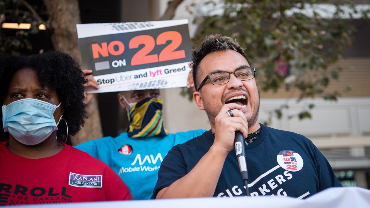 A Gig Workers Rising demonstrator speaks during a protest against Californi's Prop. 22 in 2020.