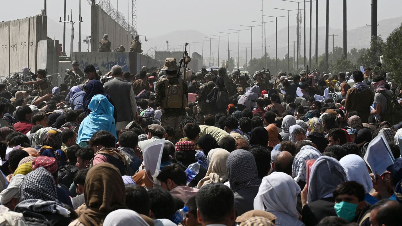 Afghans gather on a roadside near Kabul airport on August 20.