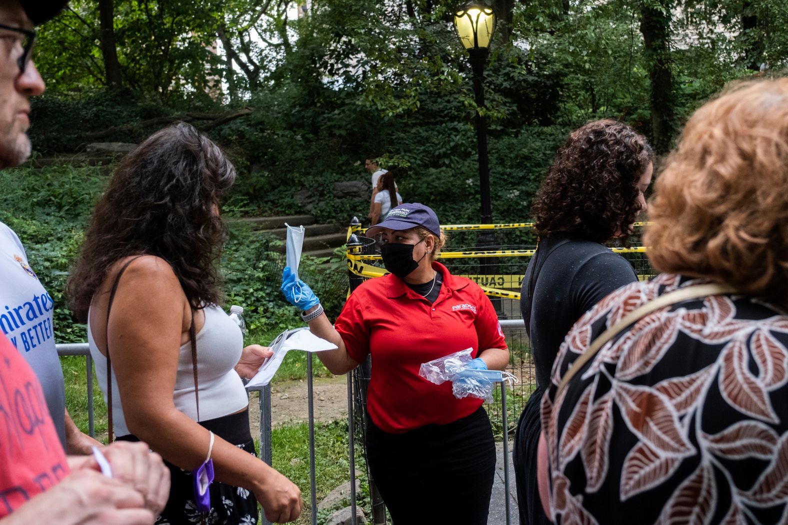 A staff member distributes free masks before the concert. 