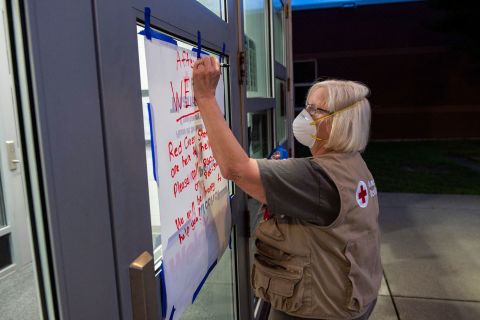 Red Cross nurse Donna Hathaway works on a welcome poster at East Lyme Middle School, which has been serving as a shelter in New London, Connecticut, on August 21.
