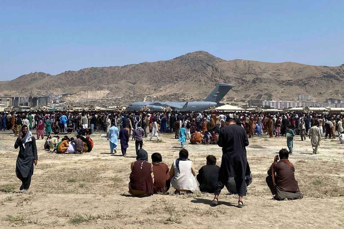 Hundreds of people gather near a US Air Force C-17 transport plane along the perimeter at the international airport in Kabul, Afghanistan on August 16.  