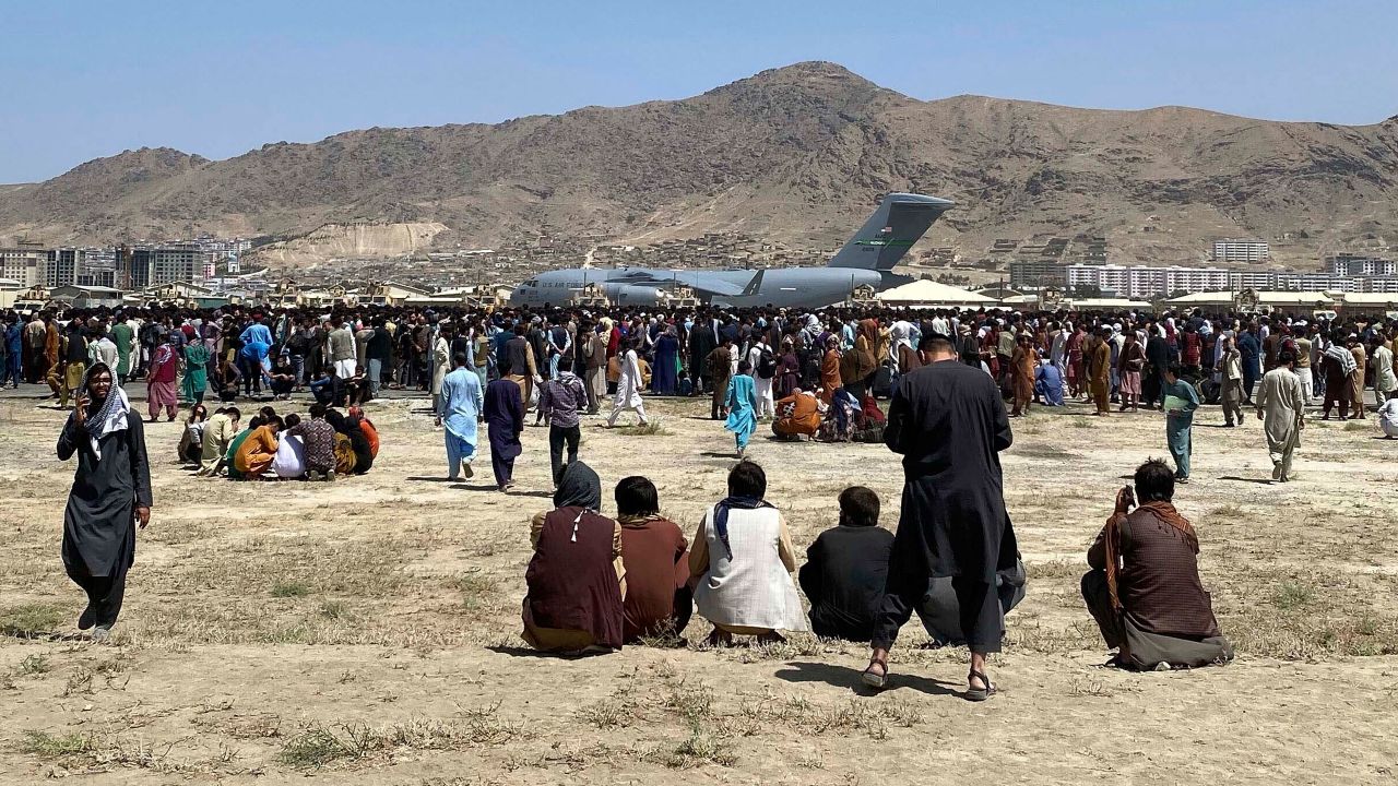 Hundreds of people gather near a US Air Force C-17 transport plane along the perimeter at the international airport in Kabul, Afghanistan on August 16.