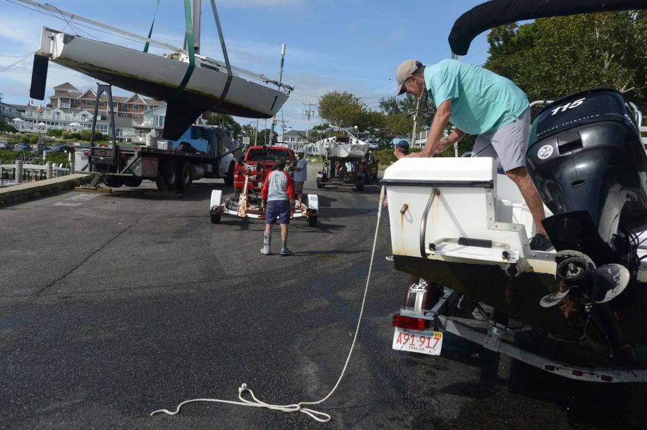 Sailboats are hauled onto trailers in Hyannis, Massachusetts, on Friday, August 20.