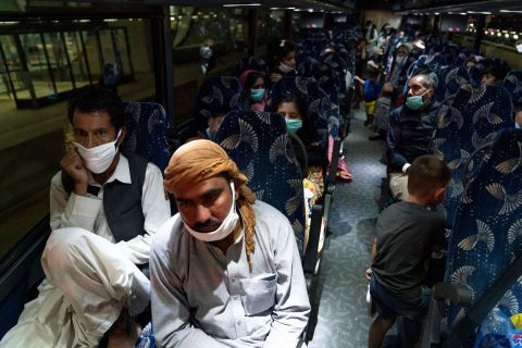 Families who fled Kabul board a bus in Chantilly, Virginia, after they arrived at Washington Dulles International Airport on August 21.