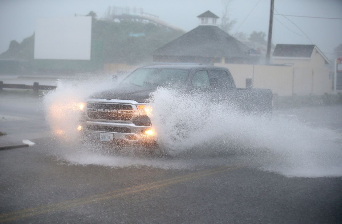 A truck drives through a flooded Atlantic Ave in Westerly, Rhode Island, as Tropical Storm Henri approaches on Sunday, Aug. 22.