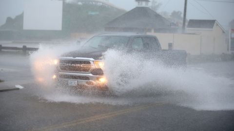 A truck drives through a flooded Atlantic Ave in Westerly, Rhode Island, as Tropical Storm Henri approaches on Sunday, Aug. 22.