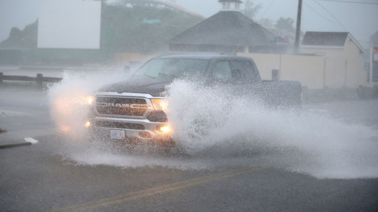 A truck drives through a flooded Atlantic Ave in Westerly, Rhode Island, as Tropical Storm Henri approaches on Sunday, Aug. 22.