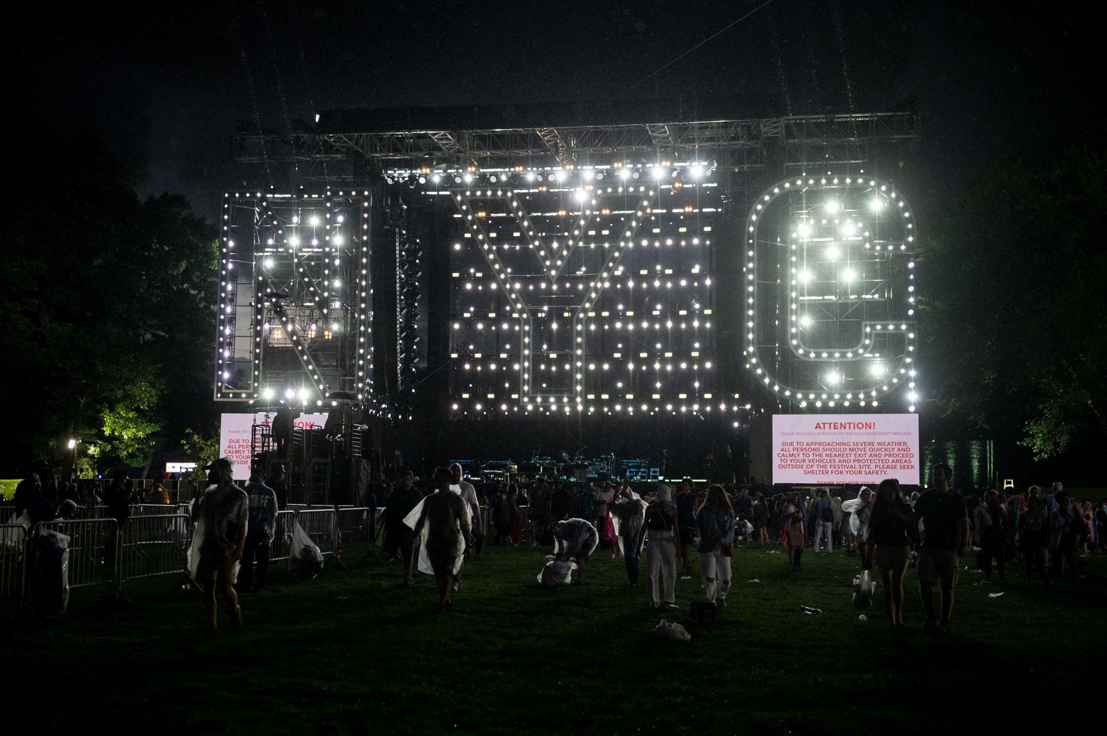 An empty stage is illuminated by the letters NYC. 