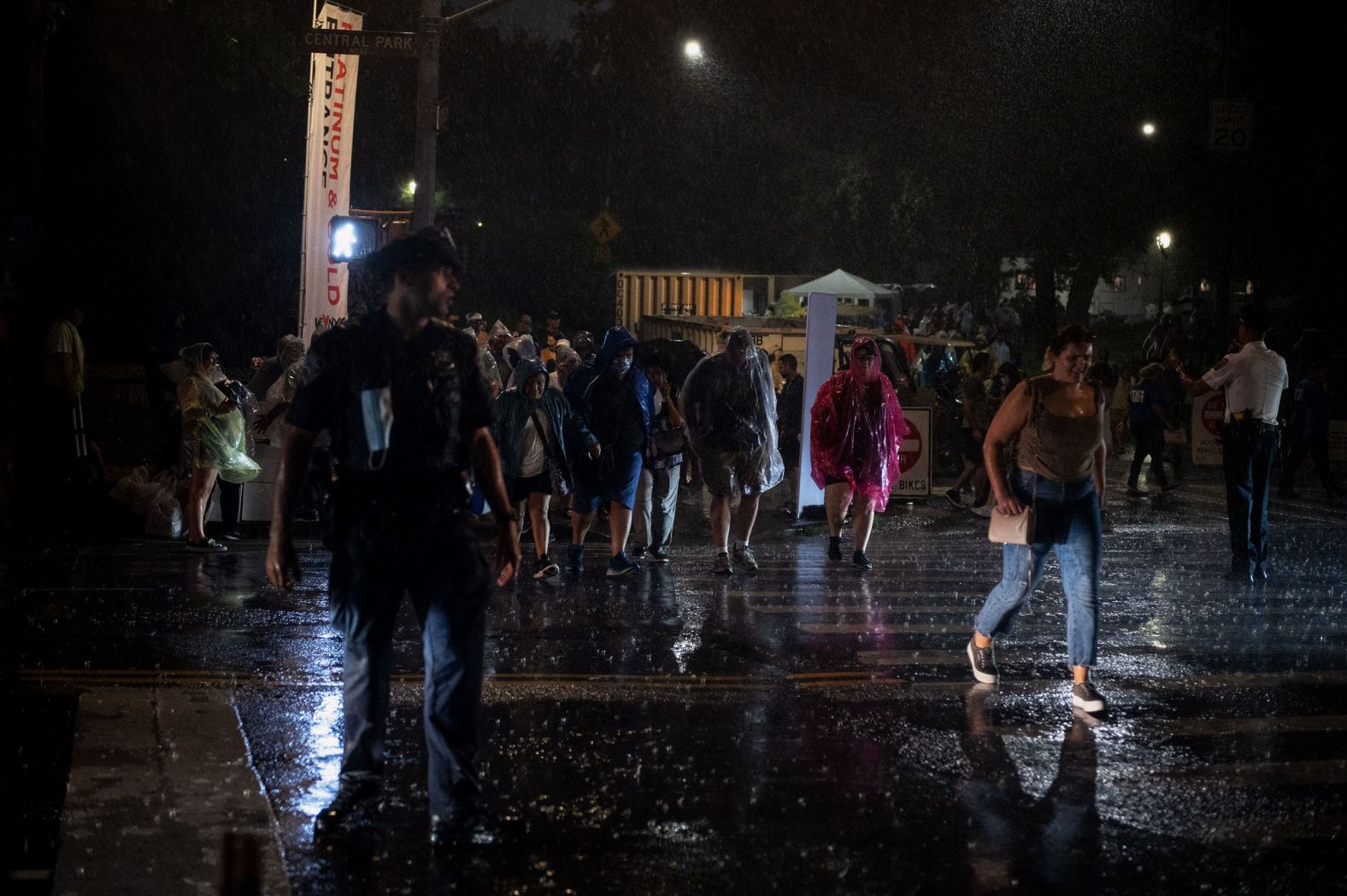 Members of the audience leave the concert in search of shelter from the storm. 