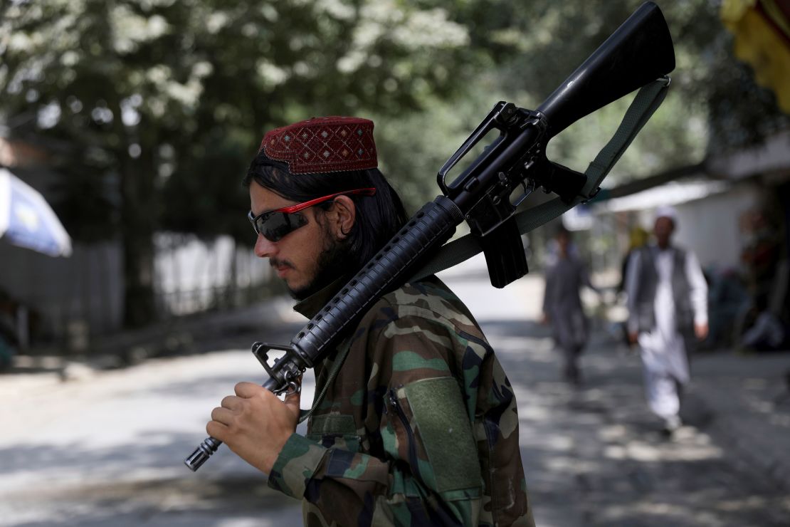 A Taliban fighter stands guard at a checkpoint in the Wazir Akbar Khan neighborhood in the city of Kabul, Afghanistan, Sunday, Aug. 22, 2021.