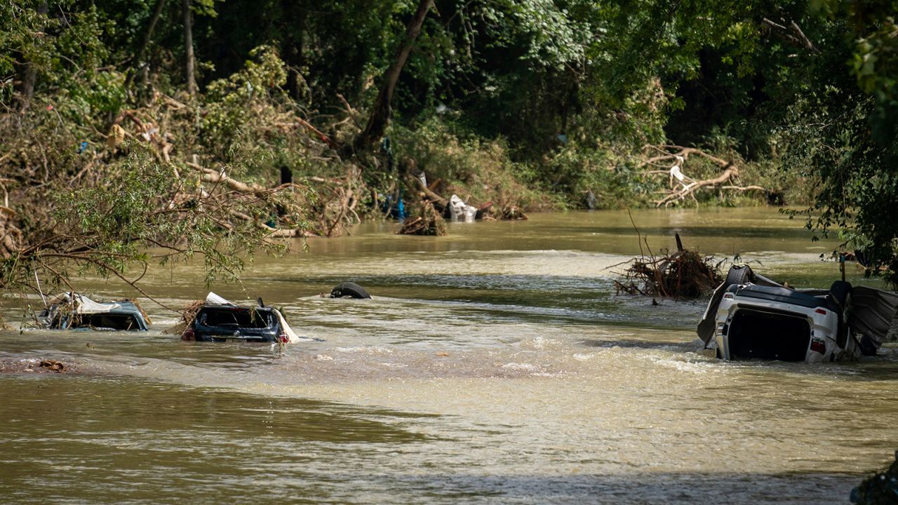 Vehicles are submerged in Trace Creek a sa result of severe weather in Waverly, Tenn., Sunday, Aug. 22, 2021. The downpours rapidly turned the creeks that run behind backyards and through downtown Waverly into raging rapids. (Andrew Nelles/The Tennessean via AP)