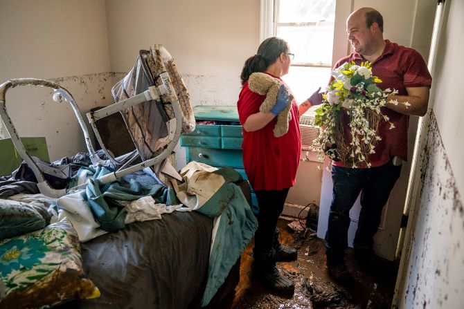 Anthony and Vanessa Yates find their wedding wreath in their flood-damaged home in Waverly, Tennessee, on August 22. Vanessa was at home with her 4-month-old daughter when the floodwaters rapidly rose. They were rescued by Vanessa's brother-in-law, Alan Wallace, who <a href="index.php?page=&url=https%3A%2F%2Fwww.cnn.com%2F2021%2F08%2F24%2Fus%2Ftennessee-flooding-tuesday%2Findex.html" target="_blank">paddled his kayak</a> to their house.