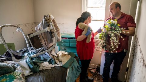 Anthony and Vanessa Yates find their wedding wreath in their flood-damaged home in Waverly, Tennessee, on August 22. Vanessa was at home with her 4-month-old daughter when the floodwaters rapidly rose. They were rescued by Vanessa's brother-in-law, Alan Wallace, who <a href="https://www.cnn.com/2021/08/24/us/tennessee-flooding-tuesday/index.html" target="_blank">paddled his kayak</a> to their house.
